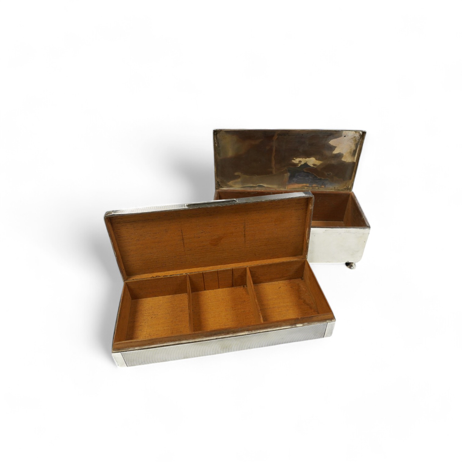 A George V engine turned silver cigarette box, by Padgett & Braham Ltd, London, 1935, 21.6cm and an earlier Irish silver cigarette box. Condition - poor to fair